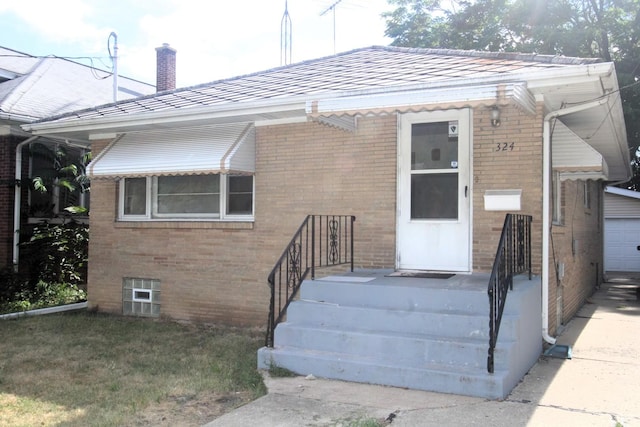324 Illinois St, Joliet, IL 60436 - view of front of property with brick siding, a chimney, and a garage