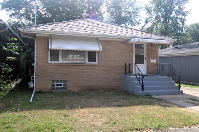 324 Illinois St, Joliet, IL 60436 - bungalow featuring brick siding and a front lawn