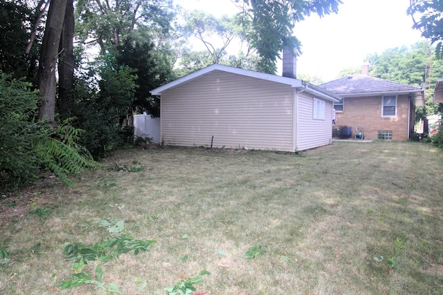 324 Illinois St, Joliet, IL 60436 - view of home's exterior with a chimney, brick siding, and a yard