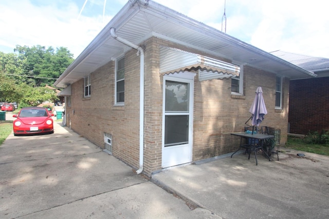324 Illinois St, Joliet, IL 60436 - view of side of home with brick siding and a patio