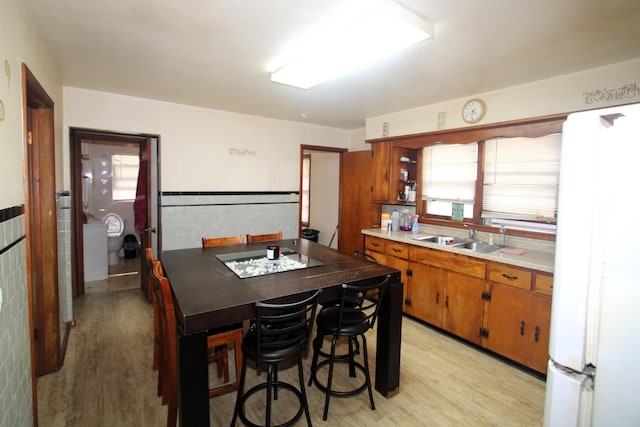324 Illinois St, Joliet, IL 60436 - kitchen featuring light wood-type flooring, brown cabinets, light countertops, and freestanding refrigerator