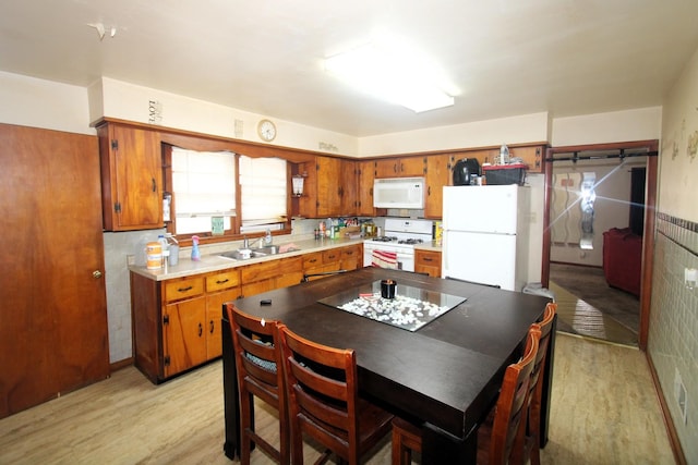 324 Illinois St, Joliet, IL 60436 - kitchen with white appliances, light wood finished floors, brown cabinets, and light countertops
