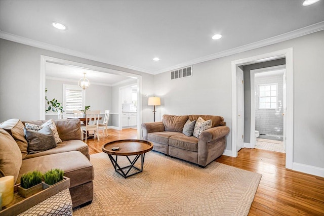 3976 Western Ave, Western Springs, IL 60558 - living area featuring light wood finished floors, recessed lighting, ornamental molding, and a chandelier