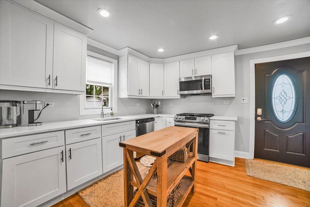 3976 Western Ave, Western Springs, IL 60558 - kitchen with stainless steel appliances, light countertops, white cabinets, recessed lighting, and light wood-style floors