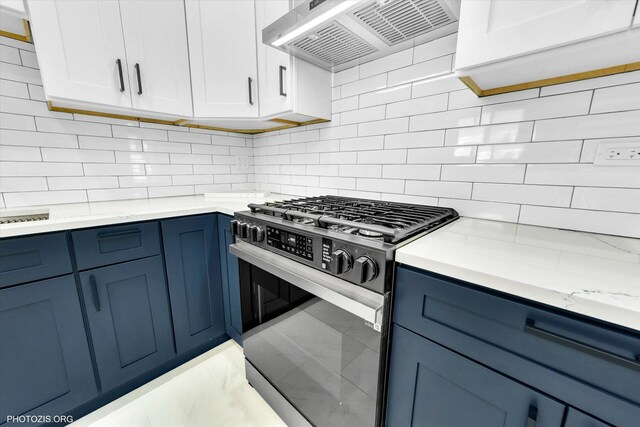 6100 W Byron St, Chicago, IL 60634 - kitchen with stainless steel gas stove, exhaust hood, blue cabinets, and backsplash