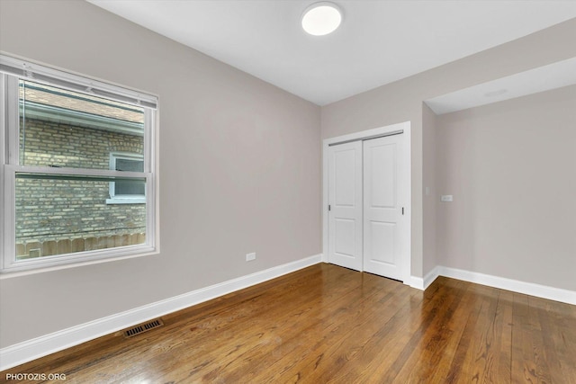 6100 W Byron St, Chicago, IL 60634 - unfurnished bedroom featuring wood finished floors and a closet