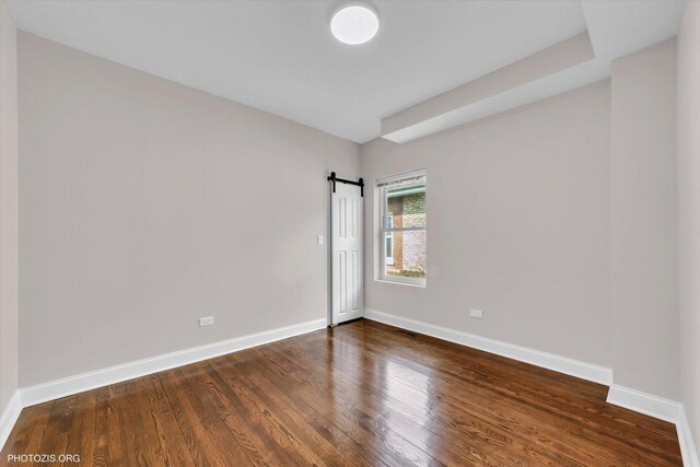 6100 W Byron St, Chicago, IL 60634 - spare room featuring dark wood-style flooring and baseboards