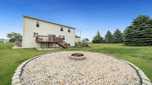 1420 Kennedy Dr, Kirkland, IL 60146 - rear view of property with a playground, stairs, a fire pit, a wooden deck, and a lawn