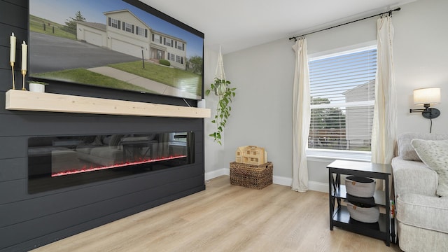 1420 Kennedy Dr, Kirkland, IL 60146 - sitting room featuring a glass covered fireplace and wood finished floors