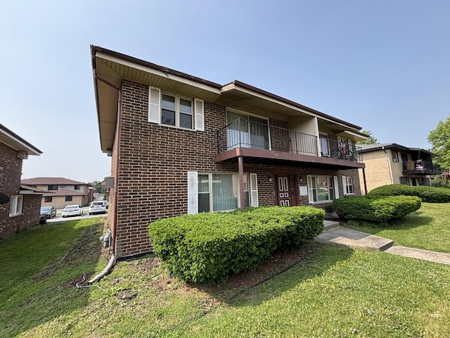 14813 Kilpatrick Ave, Midlothian, IL 60445 - view of front of house with brick siding, a balcony, and a front lawn