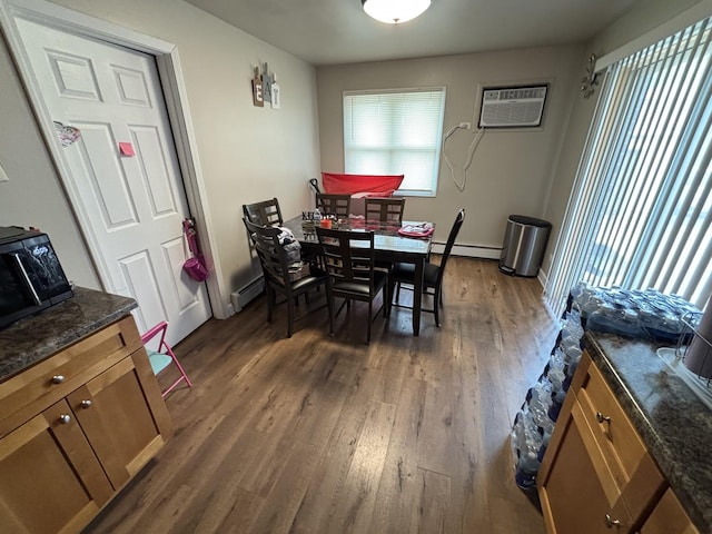 14813 Kilpatrick Ave, Midlothian, IL 60445 - dining area featuring a wall mounted air conditioner, a baseboard radiator, and dark wood-style flooring