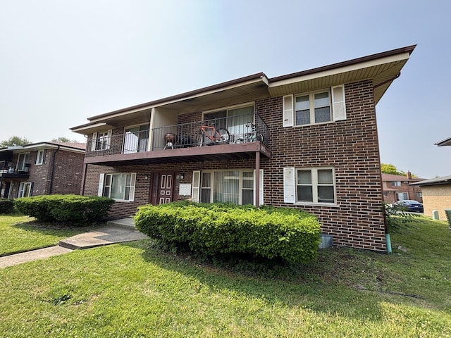 14813 Kilpatrick Ave, Midlothian, IL 60445 - view of front of house with a balcony, brick siding, and a front lawn