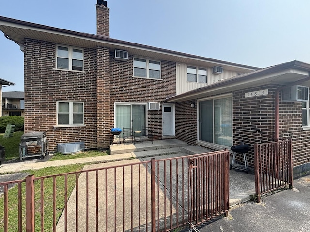 14813 Kilpatrick Ave, Midlothian, IL 60445 - rear view of property with brick siding, a chimney, a patio area, and a wall mounted air conditioner