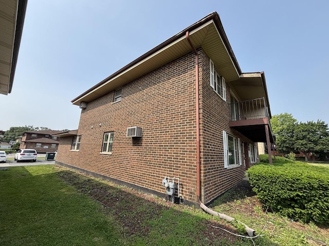 14813 Kilpatrick Ave, Midlothian, IL 60445 - view of home's exterior with brick siding, a balcony, an AC wall unit, and a yard