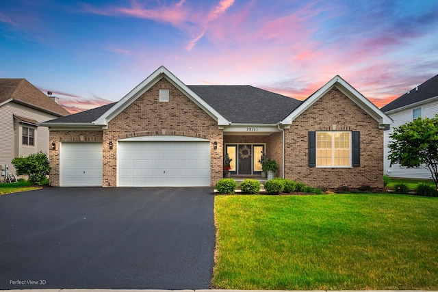 25313 W Rock Dr, Plainfield, IL 60586 - view of front of house with an attached garage, brick siding, asphalt driveway, and a front lawn