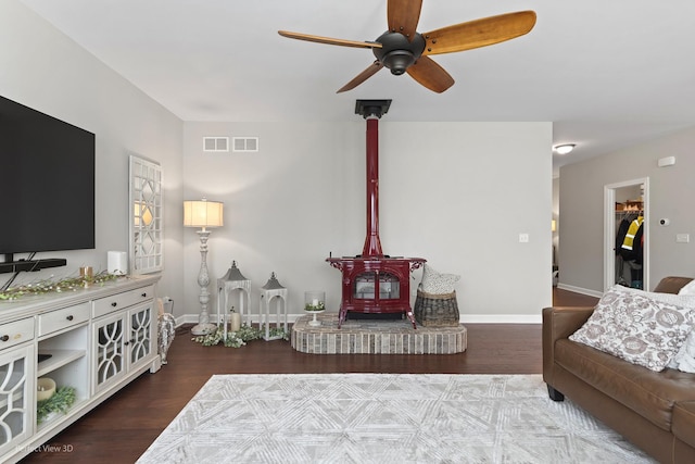25313 W Rock Dr, Plainfield, IL 60586 - living area with a wood stove, ceiling fan, and wood finished floors