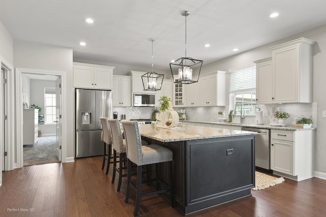 25313 W Rock Dr, Plainfield, IL 60586 - kitchen featuring stainless steel appliances, a center island, white cabinets, dark wood finished floors, and recessed lighting