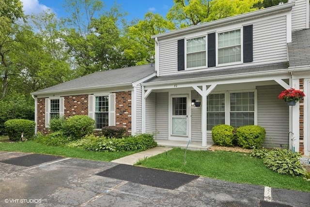 82 Hickory Ln, Cary, IL 60013 - view of front of house featuring brick siding and a porch