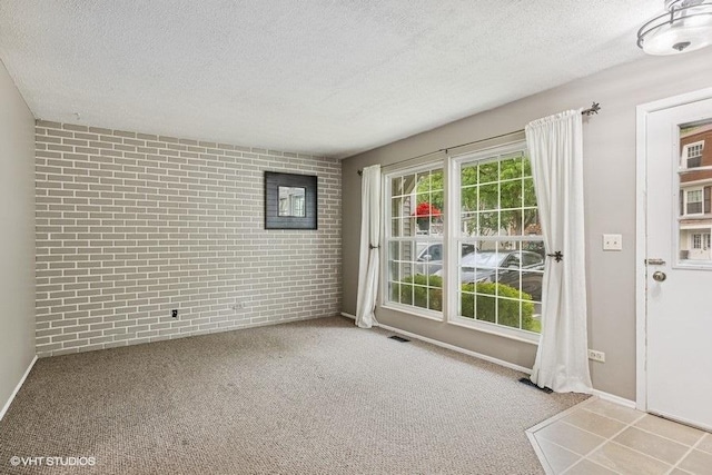 82 Hickory Ln, Cary, IL 60013 - doorway featuring brick wall, a textured ceiling, and carpet flooring