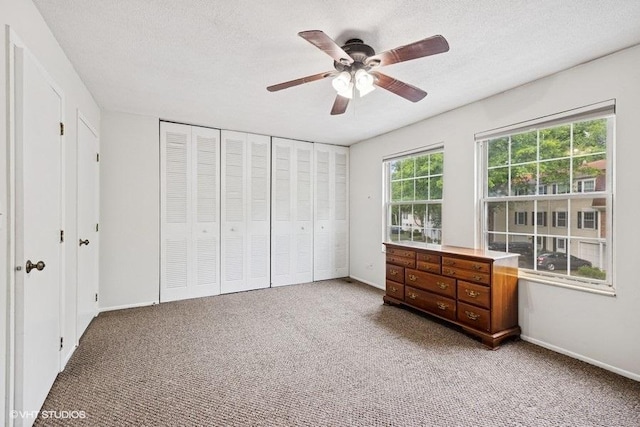 82 Hickory Ln, Cary, IL 60013 - carpeted bedroom featuring ceiling fan and a textured ceiling