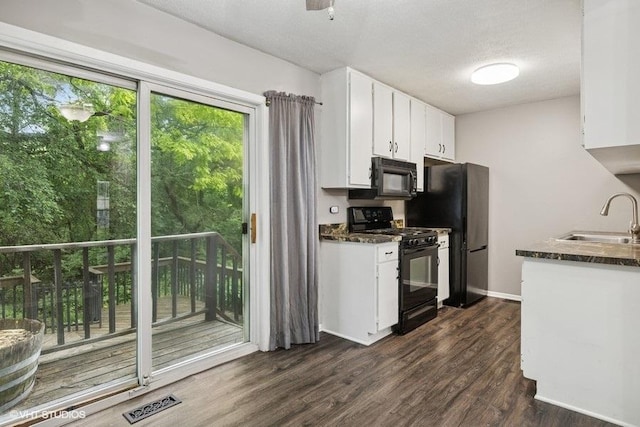 82 Hickory Ln, Cary, IL 60013 - kitchen featuring black appliances, white cabinets, and dark wood-type flooring