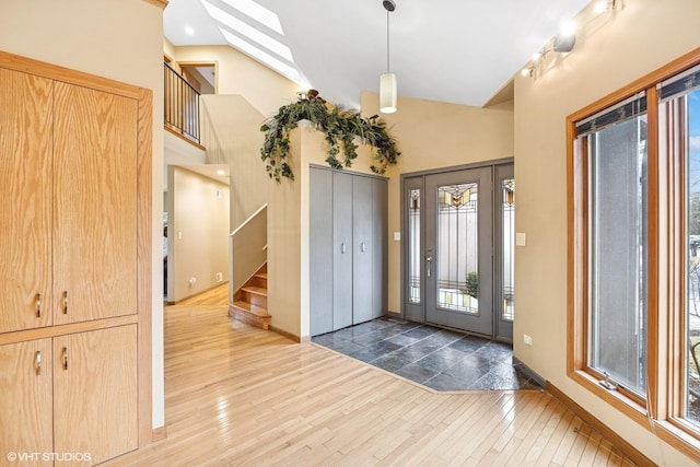 850 Willow Ln, Sleepy Hollow, IL 60118 - foyer entrance featuring stairway, wood finished floors, lofted ceiling, and a skylight