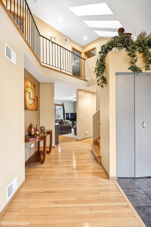 850 Willow Ln, Sleepy Hollow, IL 60118 - hall with a skylight, stairs, wood finished floors, a high ceiling, and recessed lighting