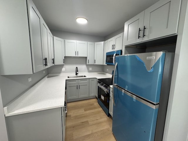 316 Marengo Ave Unit 3C, Forest Park, IL 60130 - kitchen with stainless steel appliances, light wood-style floors, and light countertops