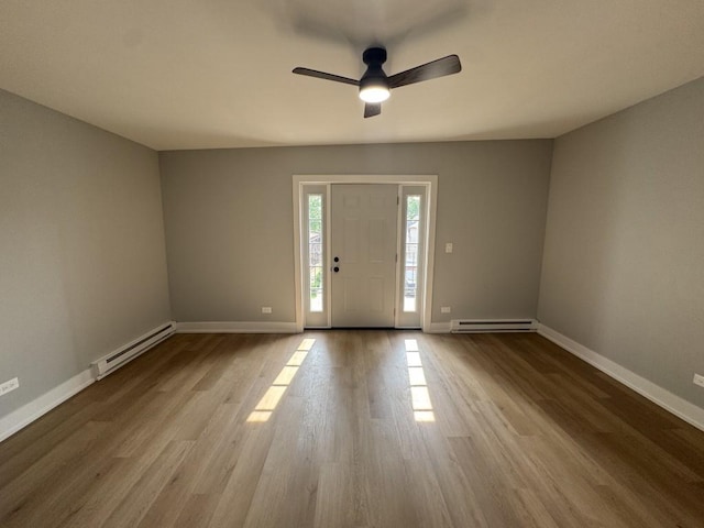 316 Marengo Ave Unit 3C, Forest Park, IL 60130 - foyer entrance featuring a baseboard heating unit, wood finished floors, and ceiling fan