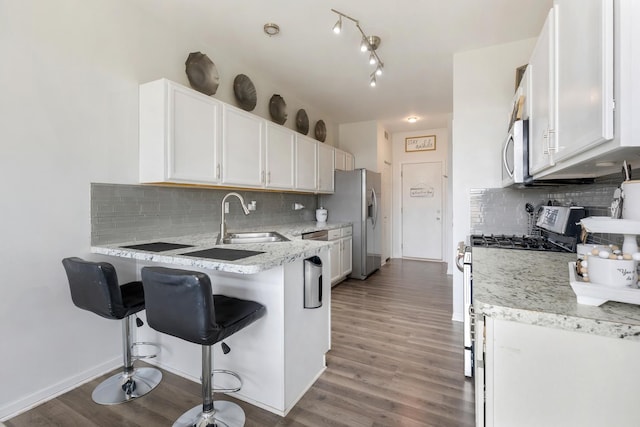 18283 Kirby Dr, Tinley Park, IL 60487 - kitchen featuring stainless steel appliances, white cabinetry, a kitchen breakfast bar, and light wood-style flooring
