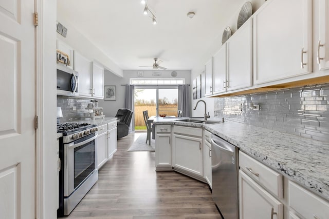 18283 Kirby Dr, Tinley Park, IL 60487 - kitchen with appliances with stainless steel finishes, ceiling fan, backsplash, wood finished floors, and white cabinets