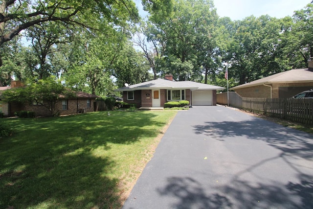 328 Dwight Ave, Joliet, IL 60436 - ranch-style house featuring asphalt driveway, a garage, brick siding, and a chimney