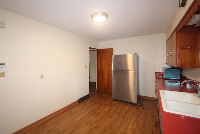 328 Dwight Ave, Joliet, IL 60436 - kitchen with freestanding refrigerator, wood finished floors, and brown cabinets