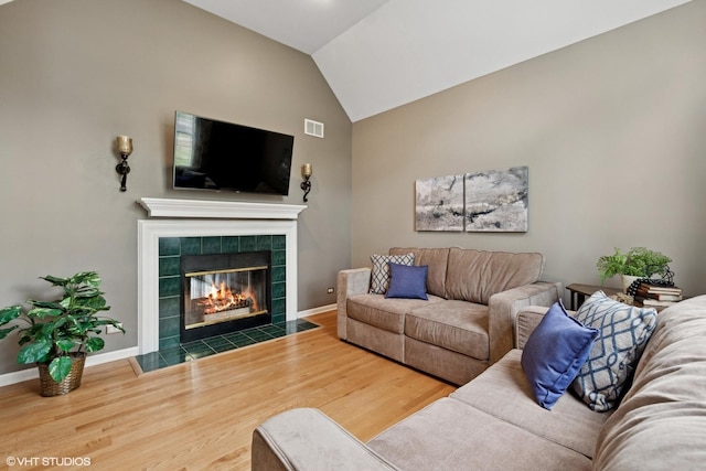 527 Capital Ln, Gurnee, IL 60031 - living room with a tiled fireplace, wood finished floors, and lofted ceiling