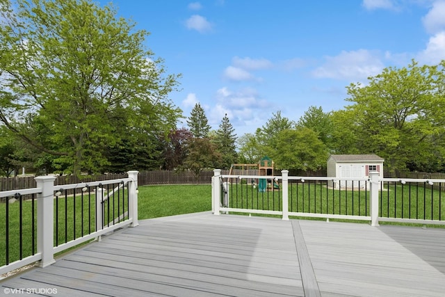 527 Capital Ln, Gurnee, IL 60031 - deck featuring a playground, a fenced backyard, a storage unit, and view of scattered trees