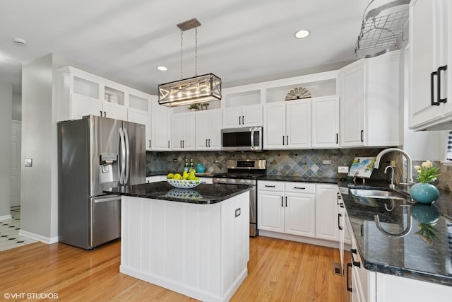 527 Capital Ln, Gurnee, IL 60031 - kitchen with stainless steel appliances, white cabinetry, backsplash, dark stone countertops, and light wood-type flooring