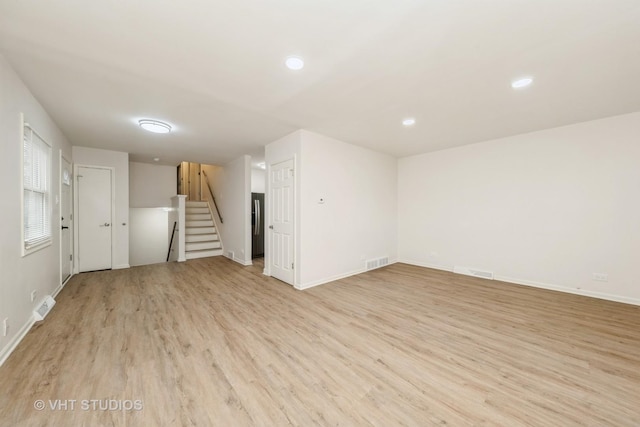 9433 S Burnside Ave, Chicago, IL 60619 - unfurnished living room with light wood-style floors, stairs, and recessed lighting