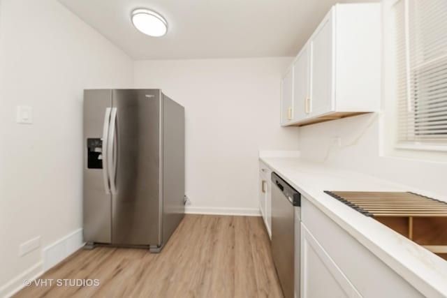 9433 S Burnside Ave, Chicago, IL 60619 - kitchen featuring stainless steel appliances, white cabinets, light wood-type flooring, and light countertops