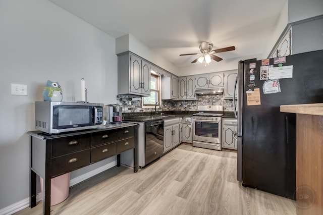 3917 Jonathan Simpson Dr, Joliet, IL 60431 - kitchen with stainless steel appliances, dark countertops, light wood finished floors, under cabinet range hood, and ceiling fan