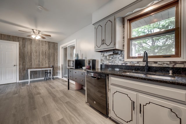 3917 Jonathan Simpson Dr, Joliet, IL 60431 - kitchen with black dishwasher, stainless steel microwave, wooden walls, a ceiling fan, and light wood-style flooring