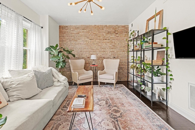 4006 W Wellington Ave Unit 3, Chicago, IL 60641 - living area with brick wall, a chandelier, and wood finished floors