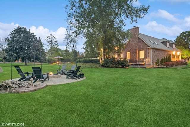 22902 W Lochanora Dr, Hawthorn Woods, IL 60047 - view of grassy yard with an outdoor fire pit, a deck, and a patio area