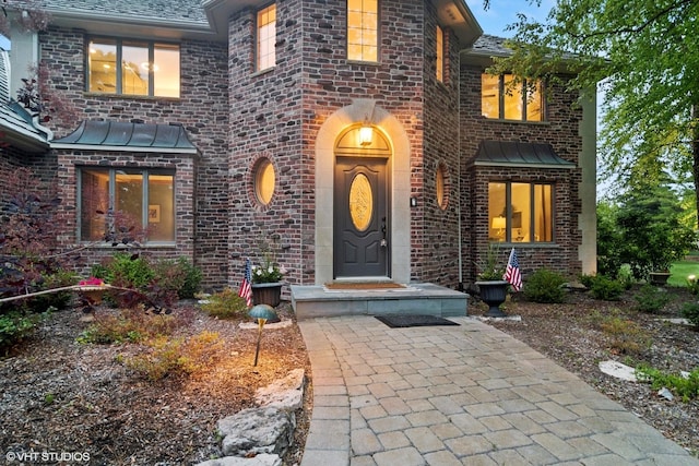 22902 W Lochanora Dr, Hawthorn Woods, IL 60047 - doorway to property featuring a standing seam roof, brick siding, and a metal roof