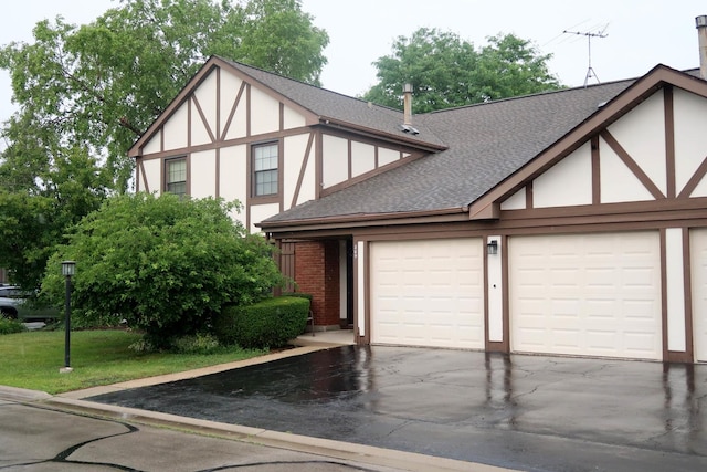 369 Ferndale Ct Unit B1, Schaumburg, IL 60193 - tudor home featuring driveway, roof with shingles, stucco siding, and a garage