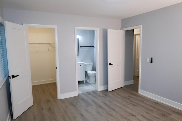 369 Ferndale Ct Unit B1, Schaumburg, IL 60193 - unfurnished bedroom with a walk in closet, wood finished floors, a closet, and ensuite bathroom