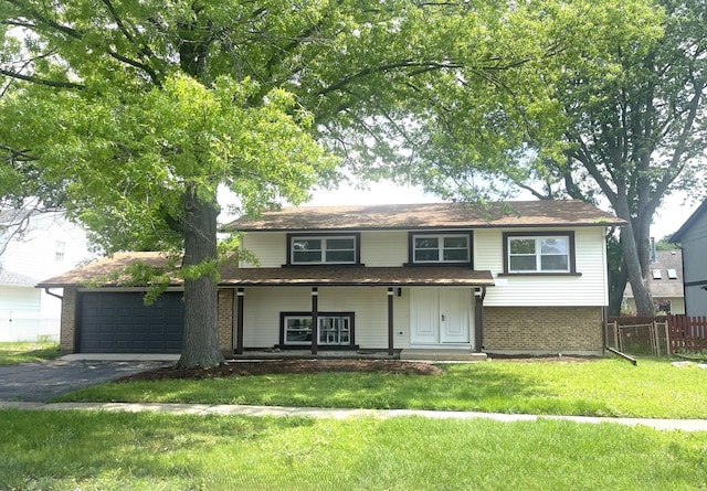 215 Brighton Rd, Elk Grove Village, IL 60007 - traditional-style house with asphalt driveway, an attached garage, brick siding, and a porch