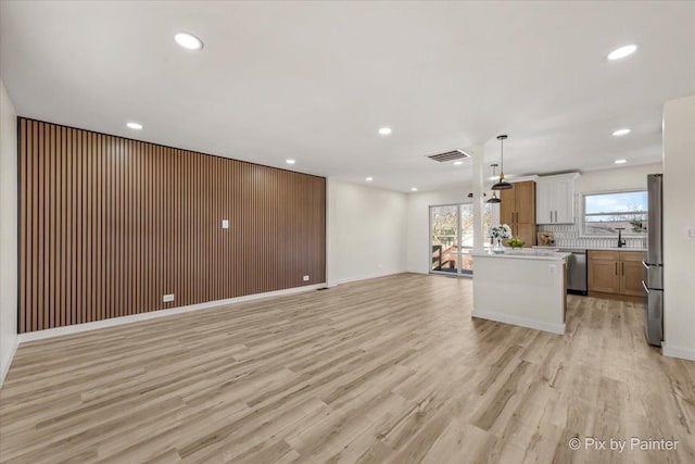 215 Brighton Rd, Elk Grove Village, IL 60007 - unfurnished living room with light wood finished floors and recessed lighting