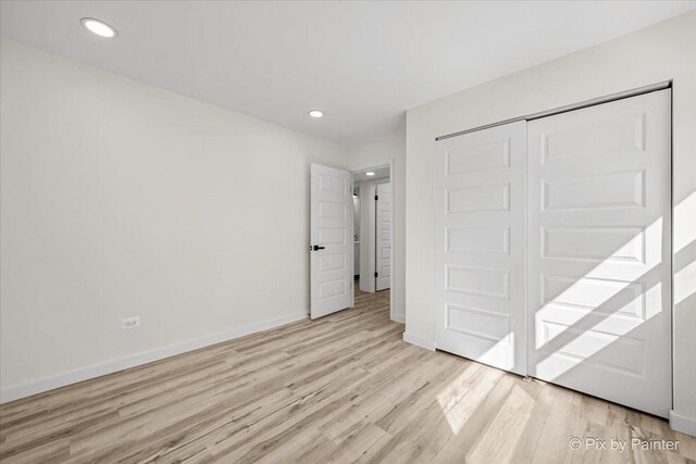 215 Brighton Rd, Elk Grove Village, IL 60007 - unfurnished bedroom featuring light wood-style flooring, a closet, and recessed lighting