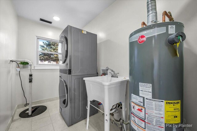 215 Brighton Rd, Elk Grove Village, IL 60007 - washroom with gas water heater, stacked washer and clothes dryer, and light tile patterned flooring