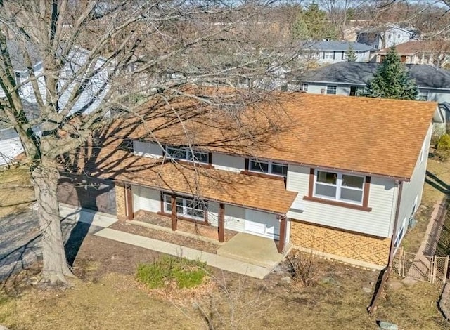215 Brighton Rd, Elk Grove Village, IL 60007 - view of front facade with brick siding and roof with shingles